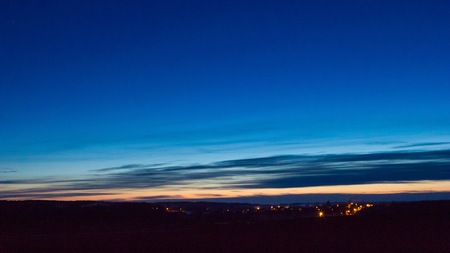 Late evening sky over village near fields. Rural landscape.の写真素材