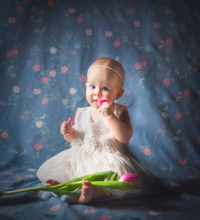 Beautiful baby girl portrait. Studio shot of 6 month old baby.の写真素材