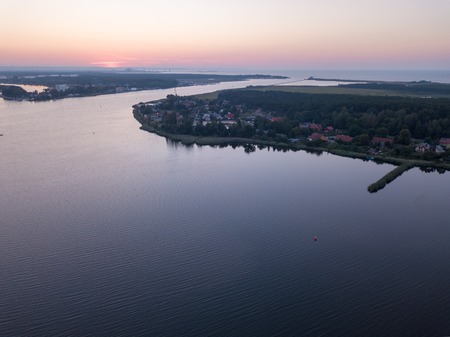 Beautiful sunset over estuary of Vistula river in Gdansk. SUmmer sunset over sea and river.の写真素材