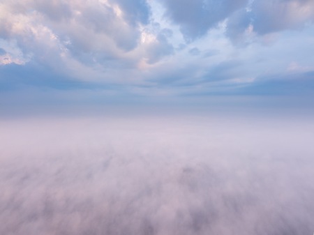 Beautiful foggy sunrise landscape from drone. Magical sunrise over the clouds.の写真素材