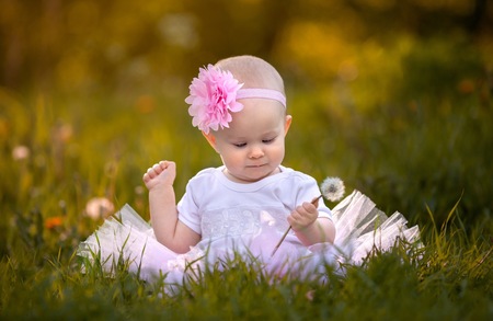 Small baby girl portrait in nature in ballerina dress.の写真素材