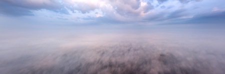 Beautiful foggy sunrise panoramic landscape from drone. Magical sunrise over the clouds.の写真素材