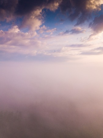 Beautiful foggy sunrise landscape from drone. Magical sunrise over the clouds.の写真素材