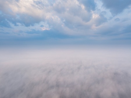 Beautiful foggy sunrise landscape from drone. Magical sunrise over the clouds.の写真素材