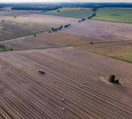 Aerial: stubble field with straw bales at late summer. Polish landscape from drone.の写真素材
