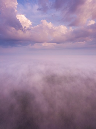 Beautiful foggy sunrise landscape from drone. Magical sunrise over the clouds.の写真素材
