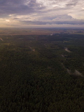 Beautfiful summer sunset over foggy european forest. Drone photographyの写真素材