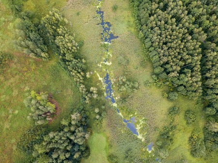 Beautiful green drone landscape with small wild river in forest. Polish landscape.の写真素材