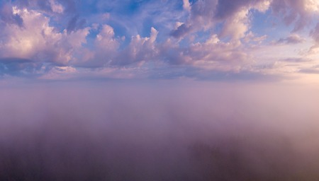 Beautiful foggy sunrise landscape from drone. Magical sunrise over the clouds.の写真素材