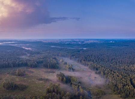 Beautiful misty evening panoramic landscape photographed from drone. Magical atmosphere.の写真素材