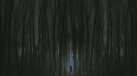 Surreal horror scene with alone strange man in dark night forest. Dreamy landscape.の写真素材