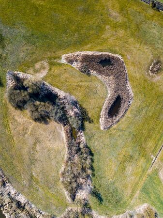 Top down aerial view with early spring meadows, pond and river. Polish landscape.の写真素材