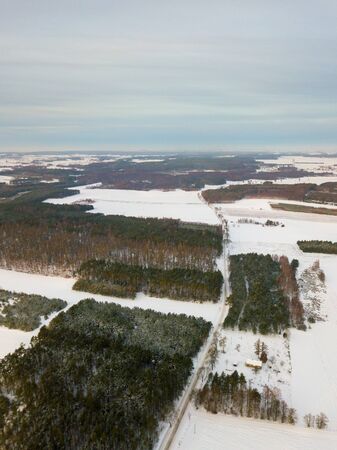 Winter aerial landscape photographed from drone. European winter with snow.の写真素材