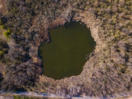 Top down aerial view with early spring meadows, pond and river. Polish landscape.の写真素材
