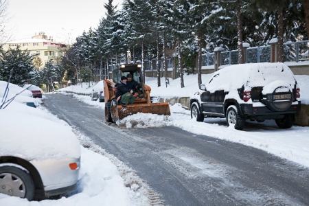 Istanbul, Turkey - February 1, 2012  Snowplow vehicle and workers are cleaning a road from ice and snow at the Istanbul streets のeditorial素材