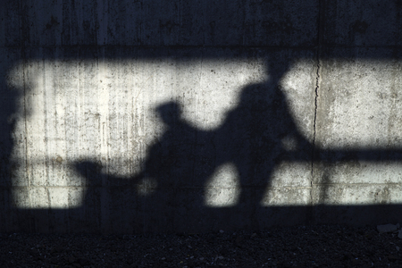 People Shadows On The Concrete Wall