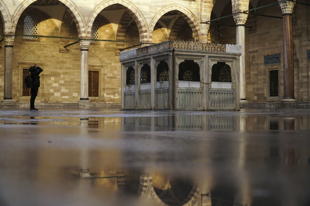 Istanbul, Turkey - February 8, 2018: The inner courtyard of Suleymaniye Mosque with reflections at Istanbul. A man is taking photo with a professional photography machine.のeditorial素材