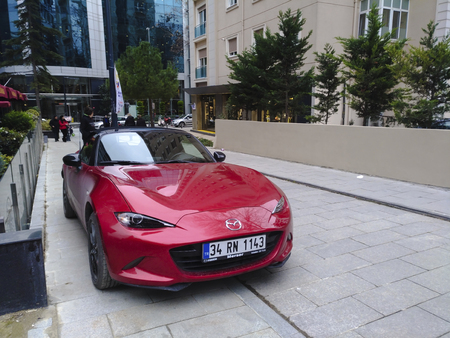 Istanbul, Turkey - February 2, 2018: A red new Mazda MX-5 at Istanbul, Kadikoy, Caddebostan District at street with some people and stores.のeditorial素材