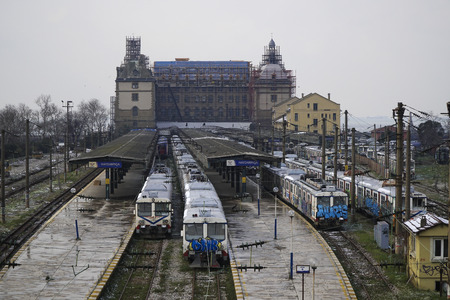 Istanbul, Turkey - March 1, 2018 : There is a major restoration at The Haydarpasa Train Station Building at Istanbul, Kadikoy. Some old trains covered with graffiti writings.のeditorial素材