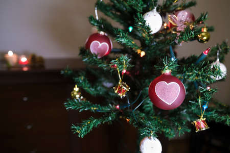 Christmas tree and heart shaped balls with candlesの写真素材