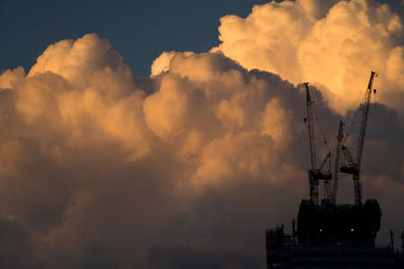 Sunset storm clouds and industrial cranes at Istanbul Turkeyの写真素材