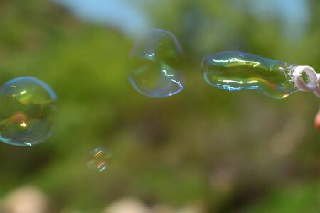 Soap bubbles on a green sphereの写真素材