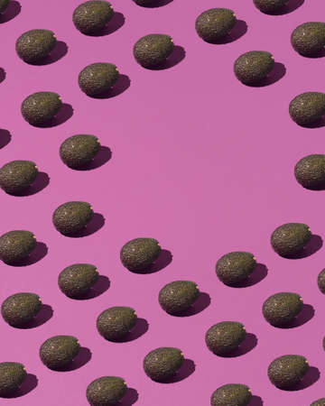 Creative pattern made of avocado agnaist vibrant purple background.Flat lay.Minimalism.