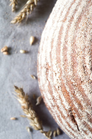 Tasty rustic artisan bread on a kitchen towelの写真素材