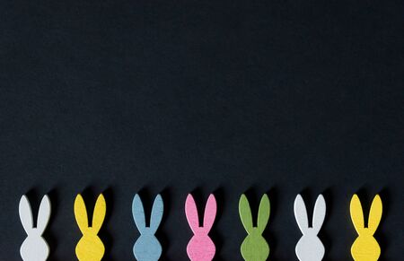 Easter bunnies ears in various colors on black background. Easter holidays backgroundの写真素材