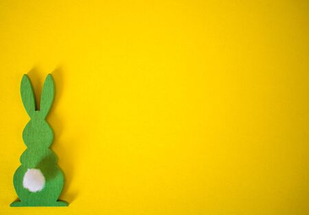 Green Easter bunny on yellow background. Easter holidays yellow backgroundの写真素材