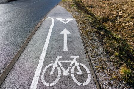 End of bicycle lane. Bicycle symbol painted white on asphalt