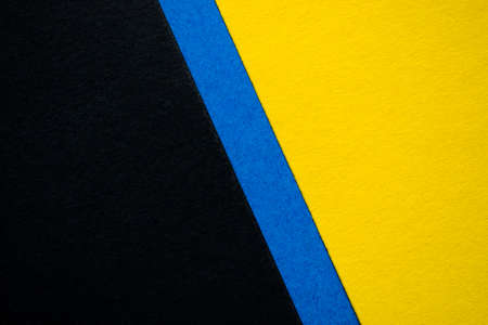 Yellow and black background diagonally divided with blue stripe.の写真素材