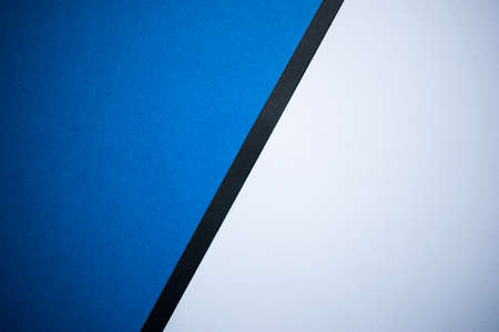 Diagonally divided white and blue colored paper with black lineの写真素材