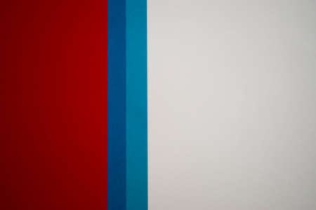 White, blue and red vertically divided colored paper backgroundの写真素材