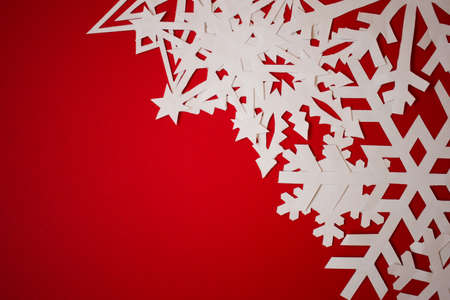 Christmas greeting card with paper snowflakes on red backgroundの写真素材