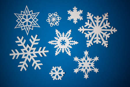 Various paper snowflakes on blue backgroundの写真素材