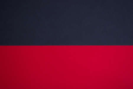 Horizontally divided black and red colored paper abstract background
