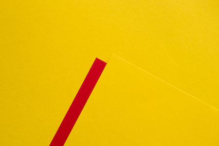 Yellow on yellow background with red stripeの写真素材