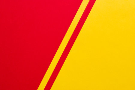 Diagonally divided red and yellow contrast backgroundの写真素材