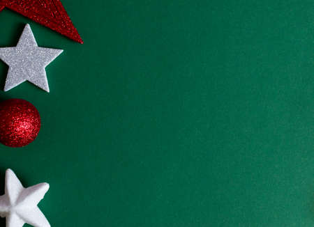 White and red Christmas decorations on green background. Christmas blank greeting cardの写真素材