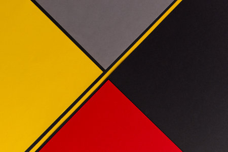 Yellow, gray, black and red diagonally divided backgroundの写真素材