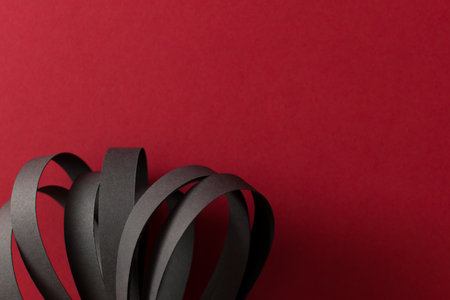 Black curved stripes on red background, copy spaceの写真素材