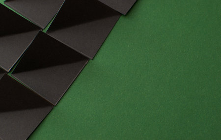 Black 3d geometric shapes on green background, copy spaceの写真素材