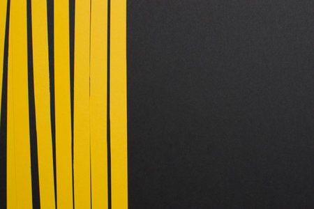 Vertical yellow stripes on black background, copy spaceの写真素材