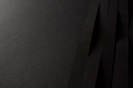 Black background with black paper stripesの写真素材