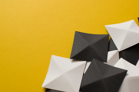 Black and white 3d shapes on yellow background