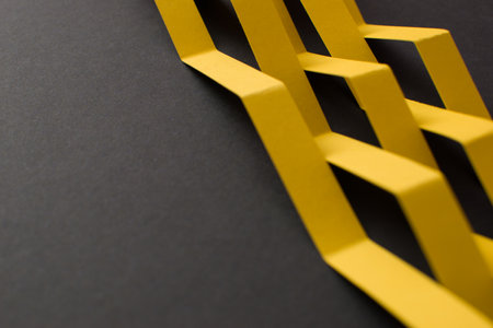 Close up of black background with yellow geometric shapesの写真素材