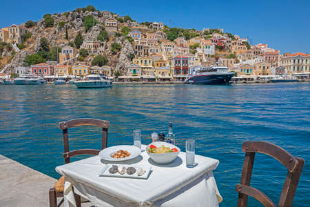Seafood,Greek tavern next to the sea at the port of Symi island Greece 15 December 2020のeditorial素材