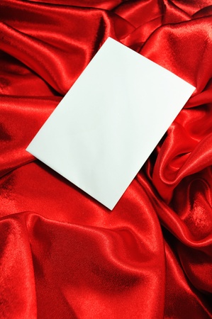 Blank card on red silkの写真素材