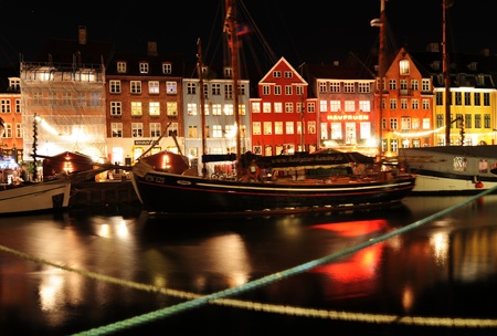 Copenhagen, Denmark - 18 Dec, 2011: Night view of old architecture and boats on the Danish channel 